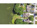 Aerial shot showcases the properties, pools, and lush greenery near a serene lake at 1324 Eckles Dr, Tampa, FL 33612