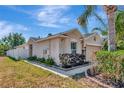 Exterior of the property with an up-close view of mature landscaping, flower beds, and a stone garden at 1505 Trailwater St, Ruskin, FL 33570