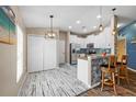 Well-lit kitchen and breakfast bar area, showcasing the stainless-steel appliances and white cabinets at 1505 Trailwater St, Ruskin, FL 33570