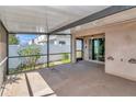 A view of the screened patio area with sliding glass doors into the house, and view of the backyard at 1505 Trailwater St, Ruskin, FL 33570