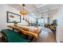 Open-concept living space featuring a unique wooden dining table and comfortable seating with a view of the balcony at 18201 Gulf Blvd # 201, Redington Shores, FL 33708