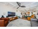 Open-concept living room featuring modern furnishings, a large television, and a unique coffered ceiling design at 18201 Gulf Blvd # 201, Redington Shores, FL 33708