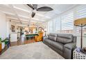 Bright and airy living room with coffered ceilings and large windows, open to the dining and kitchen area at 18201 Gulf Blvd # 201, Redington Shores, FL 33708
