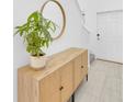 Bright entryway features a modern console table with mirror and a glimpse of the staircase at 22223 Storybook Cabin Way, Land O Lakes, FL 34637