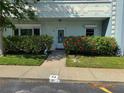Charming front entrance with lush landscaping, colorful flowers, and a welcoming pathway at 2255 Philippine Dr # 21, Clearwater, FL 33763