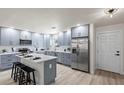 Modern kitchen with stainless steel appliances, a spacious island, and gray cabinets at 2274 66Th S Ave, St Petersburg, FL 33712