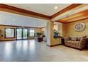 Well-lit lobby with tiled floors, seating, and view to the outside at 2323 Feather Sound Dr # F101, Clearwater, FL 33762