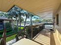 Balcony view overlooking lush greenery, mature trees, and a refreshing community pool at 2685 Sabal Springs Cir # 201, Clearwater, FL 33761