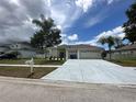 Beautiful single-story home with a three-car garage, a new driveway, and a well-kept lawn at 2816 Pankaw Ln, Valrico, FL 33596