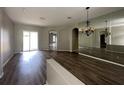 Open-concept living room featuring wood floors, and sliding glass doors to the outdoor space at 2816 Pankaw Ln, Valrico, FL 33596