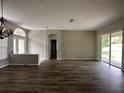 Spacious living room featuring sleek hardwood floors, neutral paint, and ample natural light at 2816 Pankaw Ln, Valrico, FL 33596