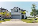 Attractive two-story house with landscaped front yard and an inviting entrance at 3047 Adams Cross Dr, Zephyrhills, FL 33540