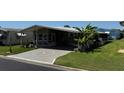 Exterior view of a single story home with covered parking and mature landscaping at 3111 Great Oak St, Wesley Chapel, FL 33543