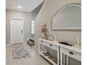 Welcoming foyer with stylish console table, decorative mirror, and neutral color palette at 31440 Barrel Wave Way, Wesley Chapel, FL 33545