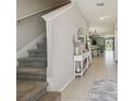 Bright foyer featuring tile floors, staircase, and an open view to the dining area at 31440 Barrel Wave Way, Wesley Chapel, FL 33545