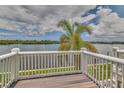 Scenic waterfront view from a private deck with white railing and a large palm tree at 3751 Pompano Se Dr # 3751, St Petersburg, FL 33705
