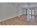 Spacious open-plan living room with contemporary wood-look flooring and neutral wall color at 3751 Pompano Se Dr # 3751, St Petersburg, FL 33705