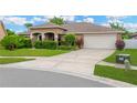 Exterior view of a home showing a long driveway leading to an attached two-car garage at 3913 Little Egret Ct, Lutz, FL 33558