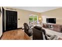 Cozy living room featuring comfortable seating, a large window, and modern entertainment center at 3913 Little Egret Ct, Lutz, FL 33558