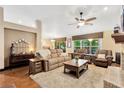 Spacious living room with high ceilings, wood floors and a ceiling fan at 3913 Little Egret Ct, Lutz, FL 33558