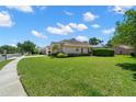 A lush lawn surrounds this charming house with a manicured hedge and ample space at 4769 Stoneview Cir, Oldsmar, FL 34677