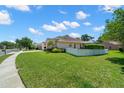 Charming single-story home with a well-manicured lawn, a white picket fence, and a screened-in patio in a friendly neighborhood at 4769 Stoneview Cir, Oldsmar, FL 34677