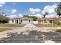 Inviting single-story home with a gray exterior, complemented by a spacious driveway at 4816 E 99Th Ave, Tampa, FL 33617