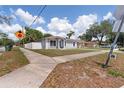 Well-maintained single-story home with a clean, bright exterior and a fenced yard at 4816 E 99Th Ave, Tampa, FL 33617