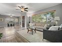 Bright living room with hardwood floors, neutral paint, large windows and stylish furniture at 6213 10Th S Ave, Gulfport, FL 33707