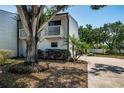 Charming two-story home featuring a double garage, dual balconies, mature trees and a welcoming driveway at 6238 92Nd N Pl # 3201, Pinellas Park, FL 33782