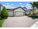 Attractive home showcasing a three car garage, paver driveway, and well-maintained landscaping at 6307 Salt Creek Ave, Apollo Beach, FL 33572