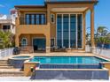 Luxury home featuring a pool with water features, a spa, and an outdoor kitchen for entertaining at 6408 Bright Bay Ct, Apollo Beach, FL 33572