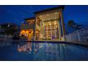 Stunning waterfront home boasts floor-to-ceiling windows overlooking a private pool and outdoor living space at 6408 Bright Bay Ct, Apollo Beach, FL 33572