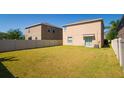 Spacious, fully fenced backyard with lush lawn and sliding glass doors, great for outdoor living at 6534 Trent Creek Dr, Ruskin, FL 33573