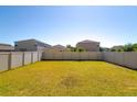 Large backyard featuring a green lawn and white vinyl fencing, offering privacy at 6534 Trent Creek Dr, Ruskin, FL 33573