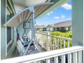 Cozy covered front porch with a swing, offering a relaxing outdoor space at 6745 Basswood Cir, Zephyrhills, FL 33542