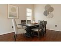 Elegant dining room featuring a dark wood table, upholstered chairs, and modern wall art at 7725 Bingham Ct, Tampa, FL 33625