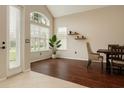 Bright living room with wood floors, tall windows, neutral colors, and minimalist decor for a modern look at 7725 Bingham Ct, Tampa, FL 33625