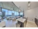 Open-concept living room with floor-to-ceiling windows and modern kitchen with marble counters at 777 N Ashley Dr # 3002, Tampa, FL 33602