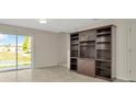 Living Room featuring a built-in bookshelf and sliding glass doors providing natural light at 8013 Savannah Sunset Ln, Tampa, FL 33615