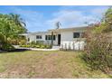 Well-maintained single-story home with manicured landscaping, a secure fence, and fresh white paint at 807 W Braddock St, Tampa, FL 33603