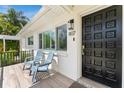 Inviting front porch featuring stylish decor, comfortable seating, and a welcoming entrance at 807 W Braddock St, Tampa, FL 33603