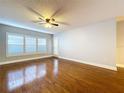 Spacious living room featuring hardwood floors, plantation shutters, and a ceiling fan at 810 Island Walk Dr # 810, Tampa, FL 33602
