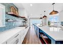Modern kitchen with custom cabinets, open shelves, stainless steel appliances and a stunning view of the water at 915 Bayshore Dr, Tarpon Springs, FL 34689