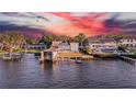 Stunning waterfront homes with private docks and boat lifts offer luxurious coastal living with breathtaking sunset views at 915 Bayshore Dr, Tarpon Springs, FL 34689