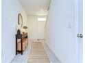 Bright home entryway featuring tiled floors, a console table, and a decorative rug at 10555 Penny Gale Loop, San Antonio, FL 33576