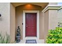 Stylish front door with decorative trim, a 'Welcome' mat, and a charming potted plant at 11523 84Th Street E Cir # 106, Parrish, FL 34219