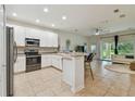 Bright kitchen with white cabinetry, stainless steel appliances, and an open layout into the living area at 11523 84Th Street E Cir # 106, Parrish, FL 34219