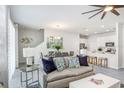 Inviting open-concept living room featuring modern decor and seamless flow into the kitchen at 11725 Blackbrook Ct, Seffner, FL 33584