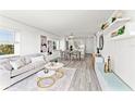 Bright living room featuring neutral decor, wood-look floors, and views into the kitchen at 1230 Gulf Blvd # 508, Clearwater Beach, FL 33767